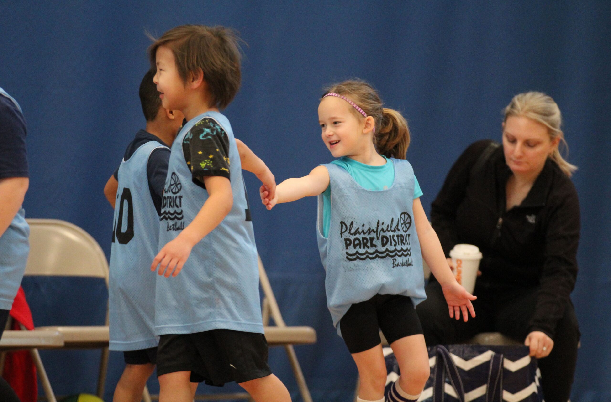 Youth basketball players giving each other a high five